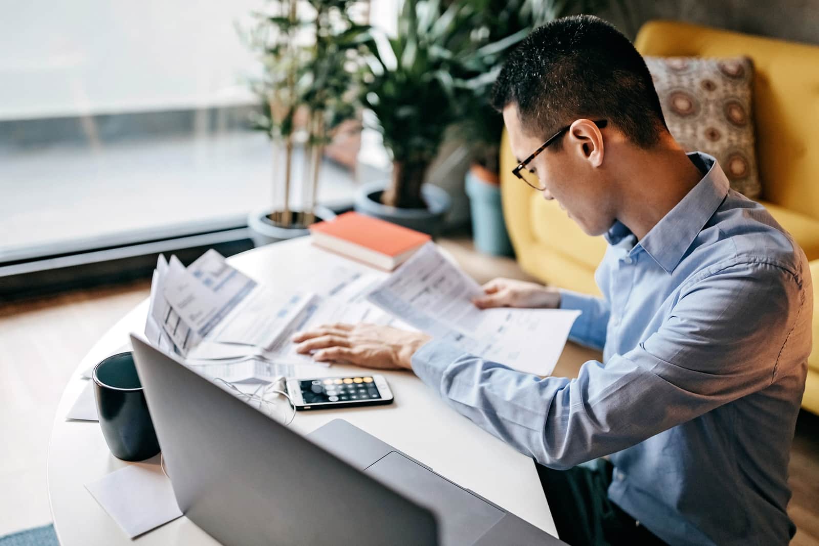 man calculating financial bills at home