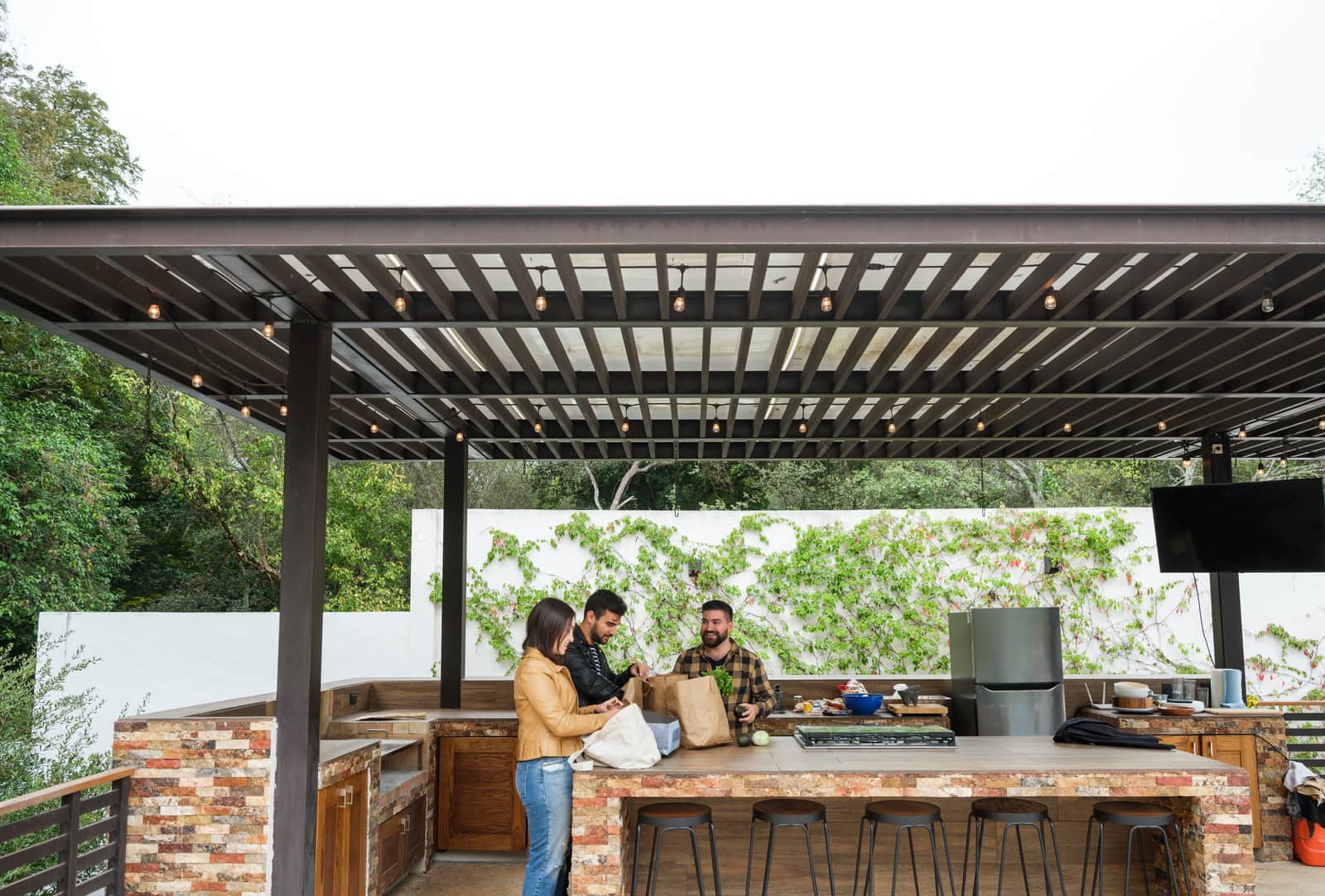 Friends getting ready for a barbecue in outdoor kitchen