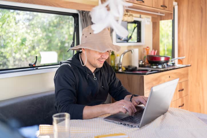 The Man İn His Caravan Works On A Laptop; tiny house