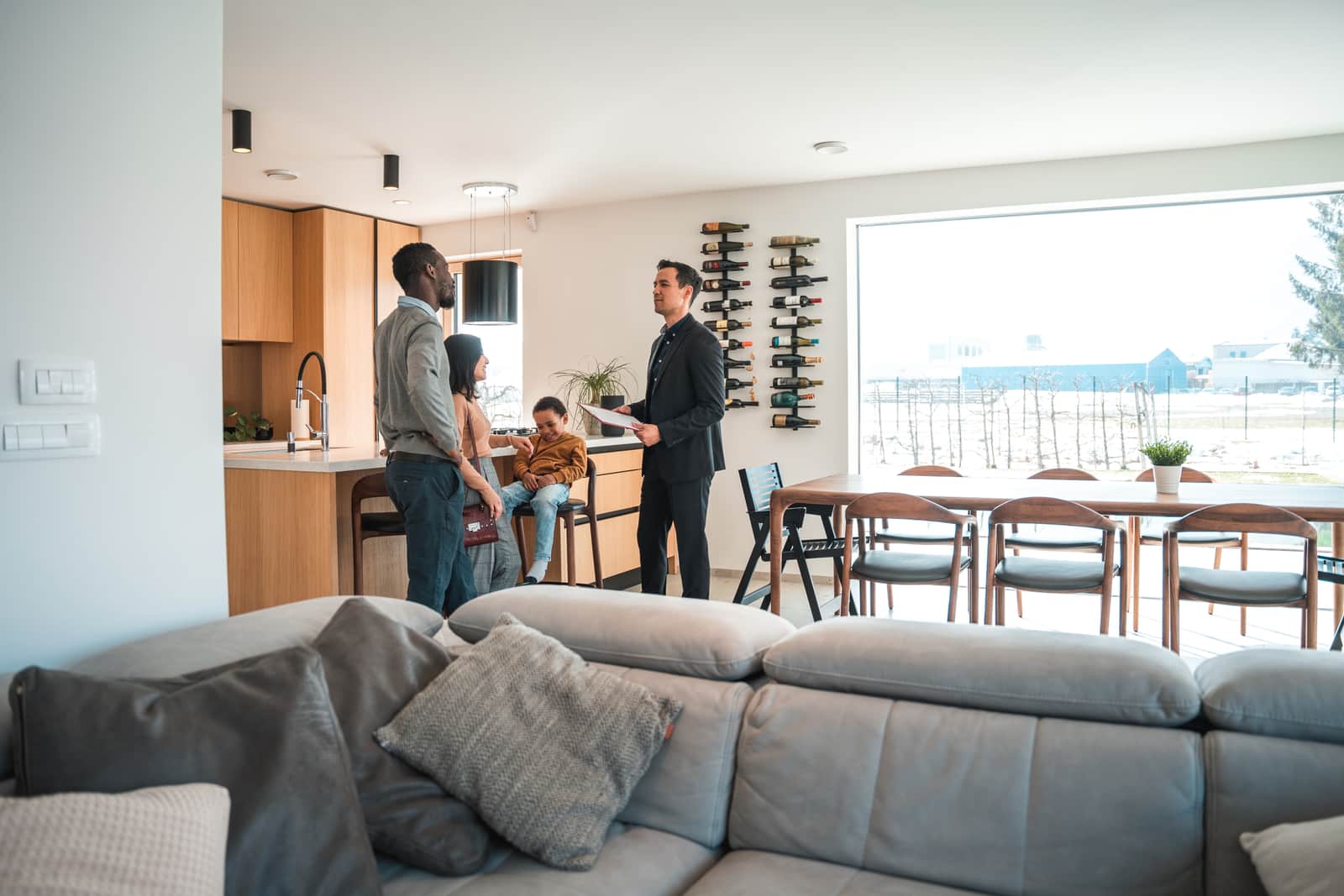 Real Estate Agent Giving A Diverse Family A House Tour