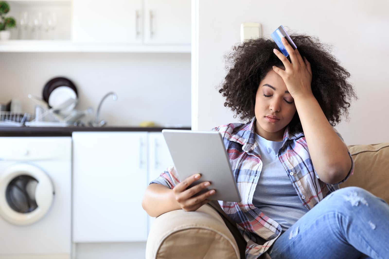Missing a payment, woman looking at tablet