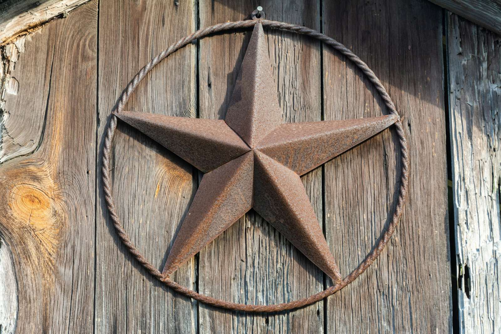 Rusty Lone Star sign on a wooden door