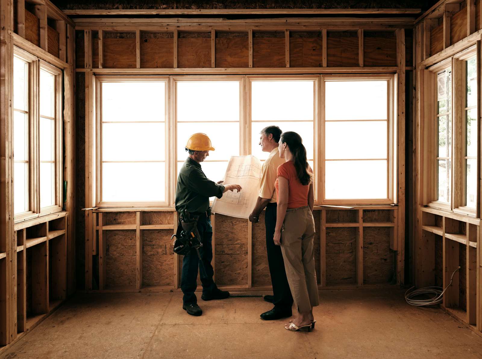 Couple talking to a Contractor during Construction