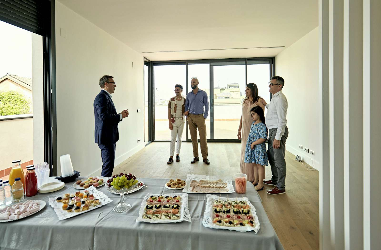 Real Estate Agent and Prospective Buyers at Open House